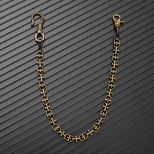 Close-up of gothic cross links and ornate vintage buckle on bronze punk wallet chain