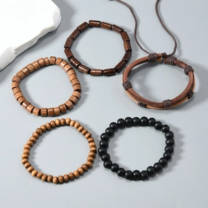 Detail of five-piece vintage bracelet set with coconut shells, wood beads, and woven leather