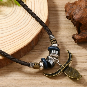 Vintage western turquoise alloy pendant necklace with leather cord and ethnic carving detail