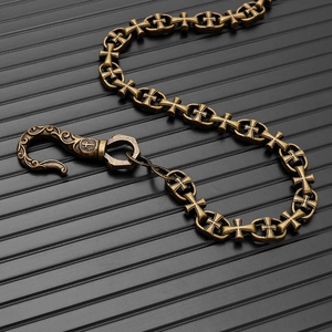 Close-up of vintage bronze gothic cross wallet chain with ornate engraved spring hook