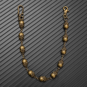 Macro shot of gothic skull links on vintage bronze pants chain with lobster clasp detail