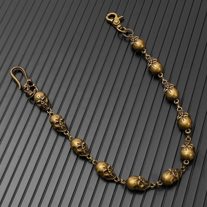 Close-up of vintage bronze skull link chain with lobster clasp for gothic punk style