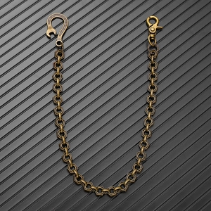 Detail of industrial punk waist chain with hexagonal nut links and engraved snap hook
