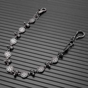 Detail of gothic silver skull trouser chain with round cross medals and metal hooks