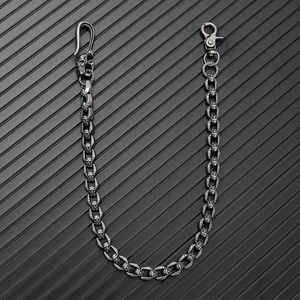 Detail of vintage silver skull wallet chain with gothic metal links and clasp closure