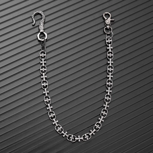Detailed close-up of gothic cross links and dual metal hooks on a vintage punk wallet chain