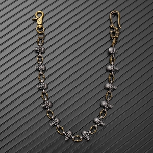 Close-up of gothic skull pants chain with antique silver and bronze metal links