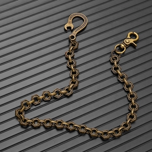 Detail of punk style brass wallet chain with nut links and wrench shaped hook connector