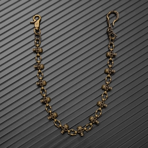 Detail of gothic bronze skull chain with lobster clasp and S-hook for biker jeans