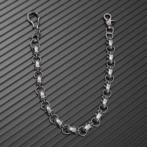 Macro shot of vintage skull chain links and metal clasps in a dark punk aesthetic