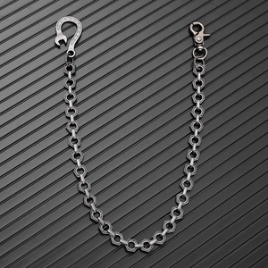 Close-up of industrial punk metal trouser chain with hexagonal nut links and wrench hook