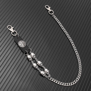 Macro view of punk skull wallet chain with silver metal links and black leather detail