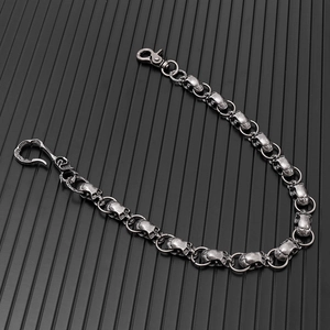 Detail of vintage silver punk wallet chain with interconnected 3D skull link design
