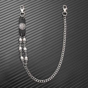 Detail view of punk leather trouser chain with metal skulls and Maltese cross emblem