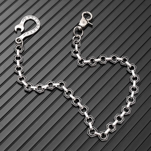 Close-up of industrial punk metal pant chain with hex nut links and wrench hook