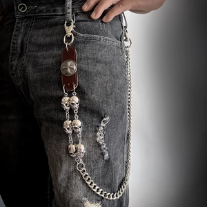 Punk leather wallet chain with silver skull charms on denim jeans for men and women