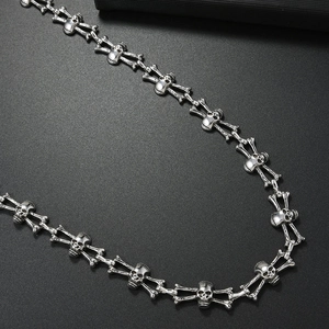 Punk style metallic skull and crossbones chain necklace with dark gothic aesthetics