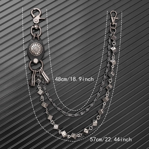 Detail of punk hip hop waist chain with dice charms and leather piece on black background