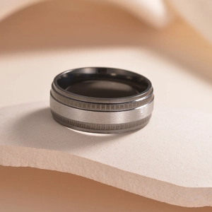 Men's titanium steel ring with silver brushed center and gear-like textured edges