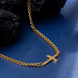 Minimalist gold tone stainless steel side-set cross pendant necklace on a curb chain