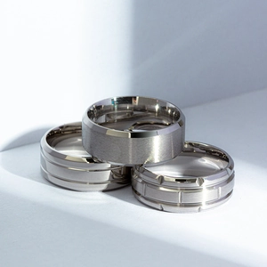 Three-piece set of men's black matte titanium steel rings with brushed and grooved finishes