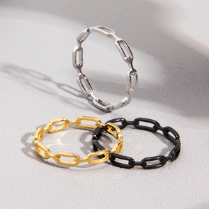 Three-piece chain link ring set in silver, gold, and black finishes with minimalist style