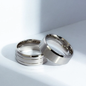 Close-up of matte and polished stainless steel rings showing brushed and grooved textures