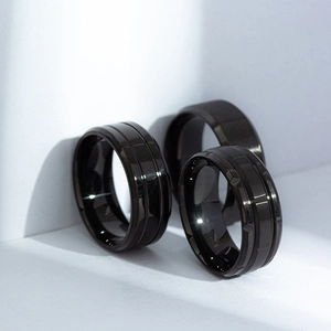 Men's matte black titanium steel ring set featuring brushed and geometric grooved textures