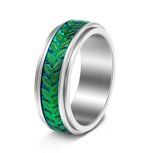 Macro detail of rotating silver olive leaf ring with green enamel finish on stainless steel