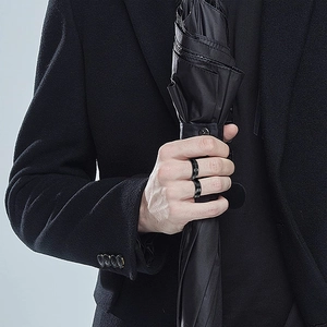 Men's black titanium spinner ring set featuring chain relief and matte textured designs