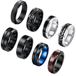 7-piece black stainless steel spinner ring set for men with brushed and textured finishes