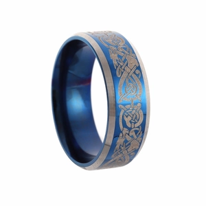 Detailed close-up of blue Celtic dragon inlay on men's stainless steel wedding ring