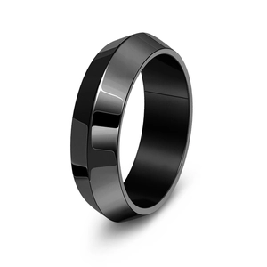 Macro view of polished black faceted stainless steel ring with modern geometric angles
