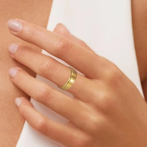 Detail of 6mm gold matte titanium steel ring with brushed finish on model finger