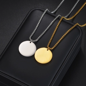 Minimalist round pendant necklaces in gold and silver steel on a premium black box