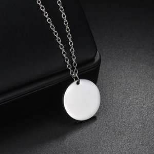 Polished silver stainless steel round pendant necklace on a premium black leather jewelry box