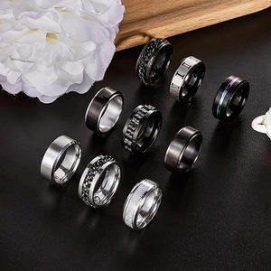 Nine-piece spinner ring set for men in black and silver finishes with gear and chain designs