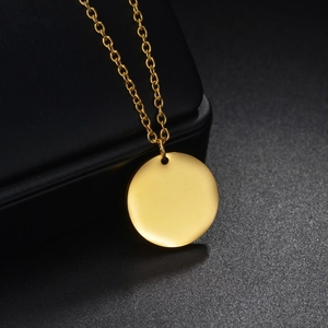 Minimalist gold plated stainless steel O-chain necklace with a round pendant on black box