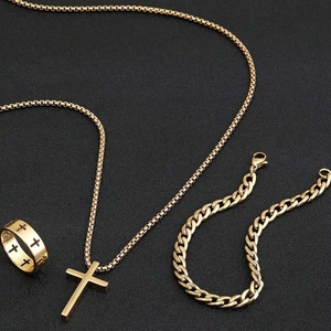 Golden stainless steel jewelry set featuring cross pendant necklace, ring and bracelet