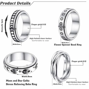 Detail of four stainless steel spinner rings showing moon, stars, and floral patterns