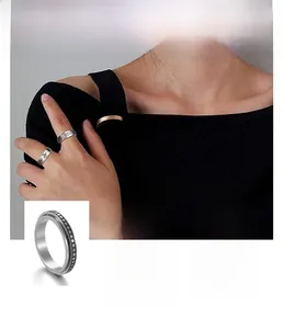 Detail view of rotatable rings featuring daisy, dot, and moon phase engraving patterns