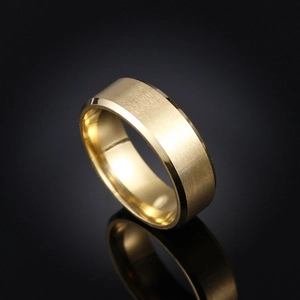 Macro view of golden titanium steel ring with brushed matte texture and polished edges