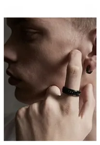 Close-up of men's black stainless steel chain ring and ear cuff set on male model