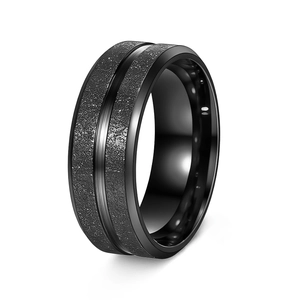 Close-up of matte black titanium steel ring with a polished silver groove and inner band