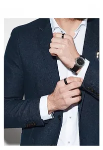 Close-up of men's navy suit paired with minimalist black titanium steel rings