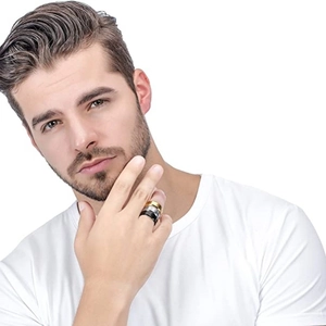 Set of three men's titanium steel rings in gold, silver, and black on a male hand
