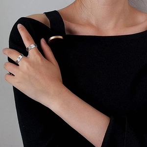 Modern spinning spinner ring set in silver steel with interlocking logo for anxiety relief