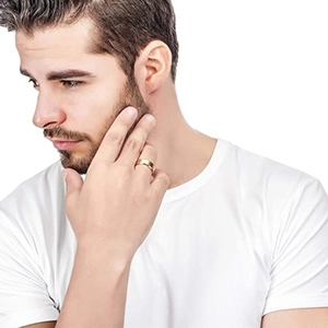 Polished minimalist gold titanium steel ring for men on male model against white background