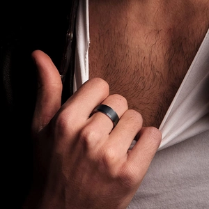 Men's matte black titanium steel ring with red inner band worn by model in trendy style