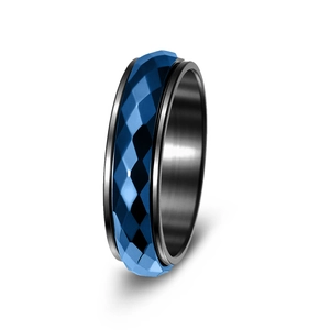 Detail of a rotating titanium steel ring with a blue faceted geometric outer band and black core